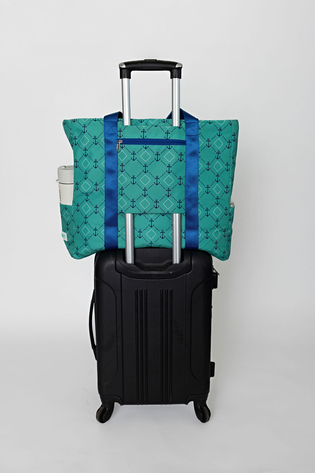 green and blue solmate tote with trolley sleeve on carry on suitcase